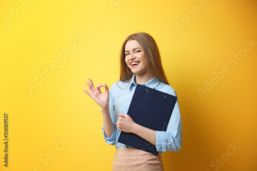 Young woman posing with cli...