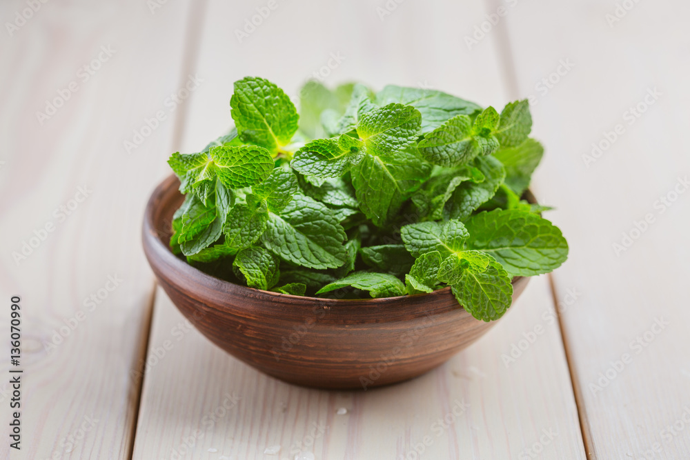 Green fresh mint om the wooden table, selective focus Green fresh mint om the wooden table, selective focus