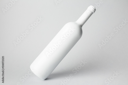 Slanted bottle on gray background