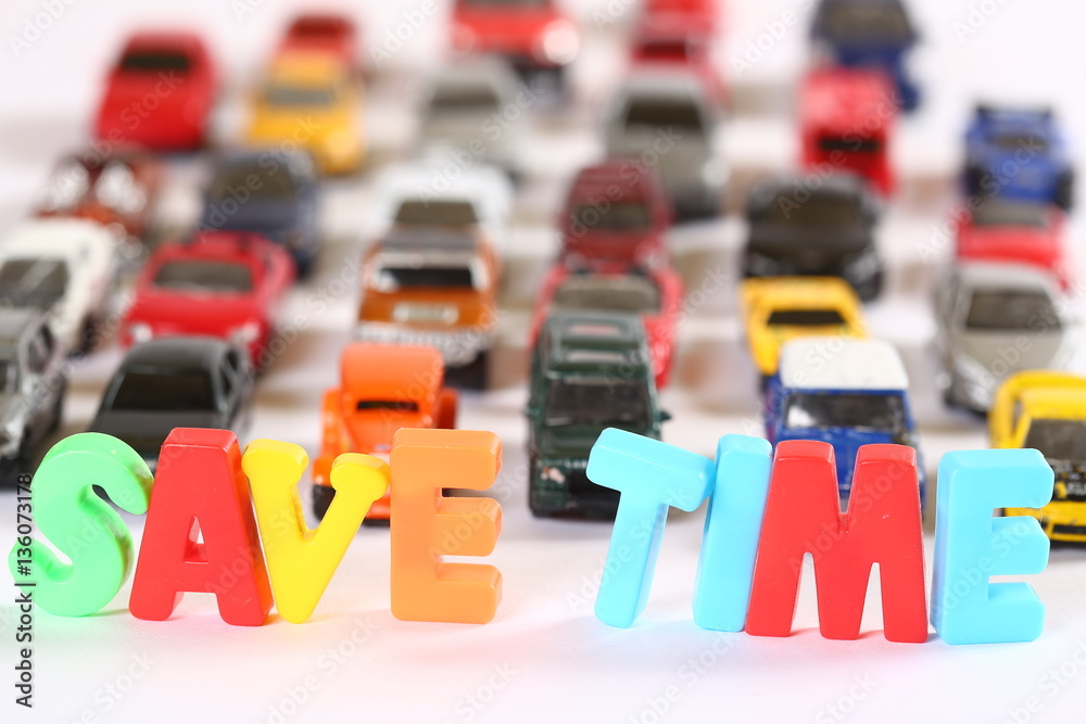 Obraz premium Toy cars with colourful letters sign SAVE TIME
