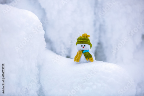 A little snowman in a hat and scarf.
