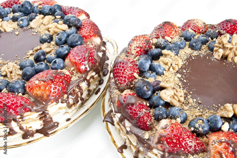 Chocolate cake decorated with glaze, strawberries and blueberrie Chocolate cake decorated with glaze, strawberries and blueberrie