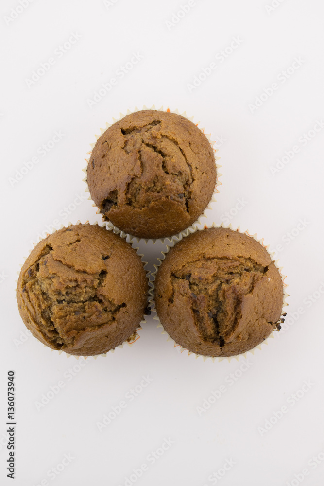 Tasty chocolate muffins on the white background Tasty chocolate muffins on the white background