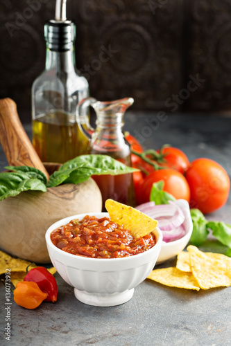 Homemade spicy tomato salsa with vegetables and olive oil