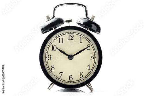black vintage alarm clock isolated on white background with refl
