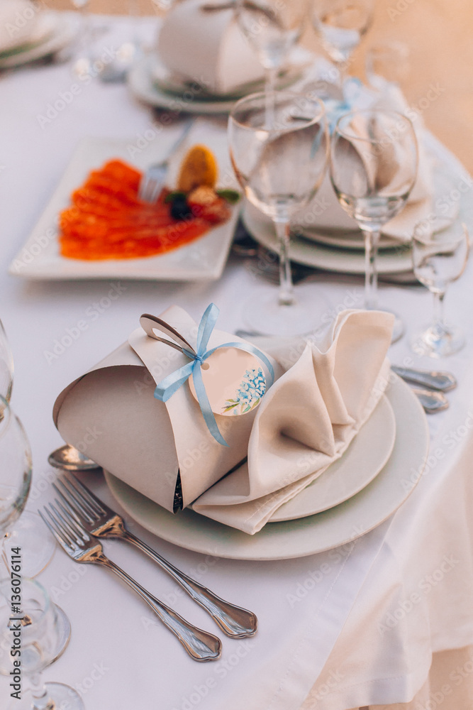 Table set for wedding or another catered event dinner. Decoration arch flowers gift box. Table set for wedding or another catered event dinner. Decoration arch flowers gift box.