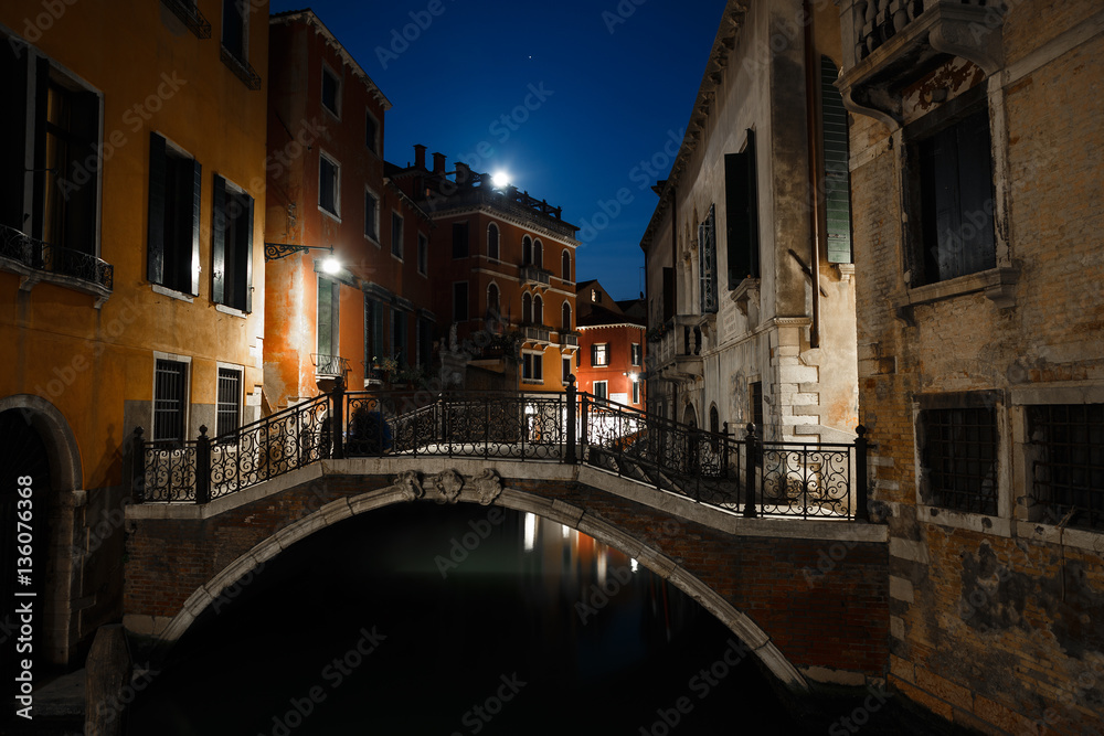 Night view of typical canal in Venice, Italy.
