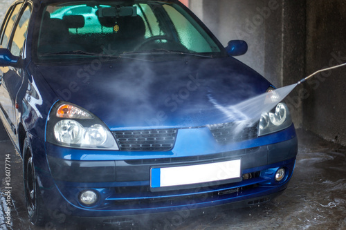 Car Wash Closeup. Washing Car by High Pressure Water © k_samurkas