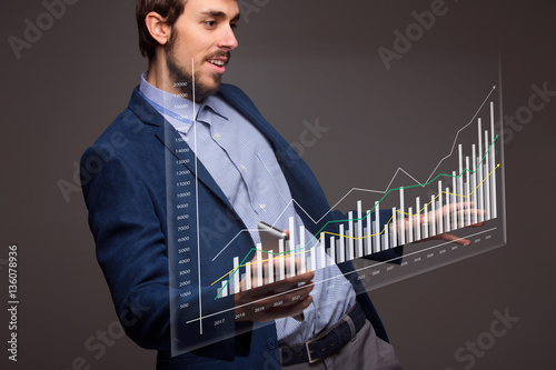 Businessman with growing chart, economy going up