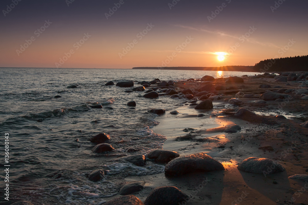 View of rocky shore at sunset