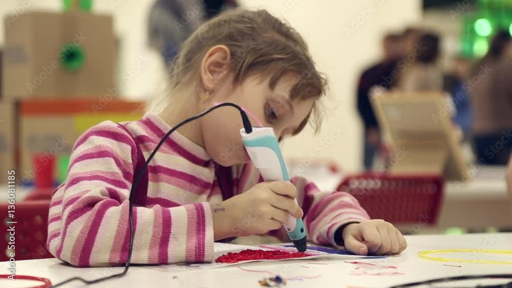 The girl paints using 3D pen, melted plastic is extruded out of the pen
The girl paints using 3D pen, melted plastic is extruded out of the pen