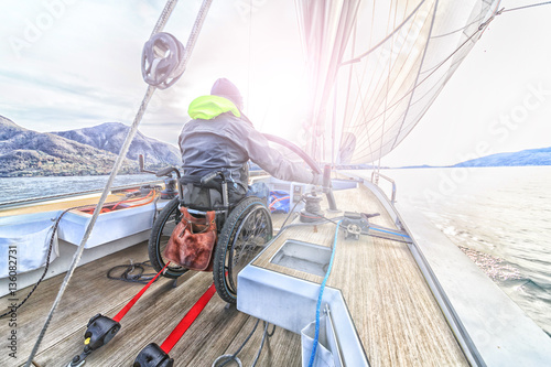 disabled man with wheelchair on sailing boat