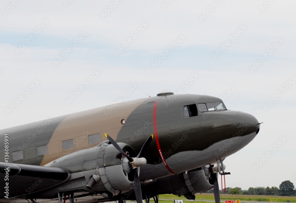 front end of a historic Douglas DC-3 Dakota painted in military colors front end of a historic Douglas DC-3 Dakota painted in military colors