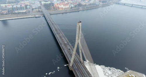 4K Aerial winter view of cable-stayed bridge over Daugava river in Riga Latvia. Vansu Bridge. photo