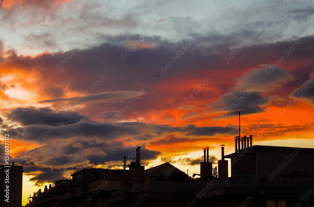 Silhouette of buildings under a red sky of clouds Silhouette of buildings under a red sky of clouds