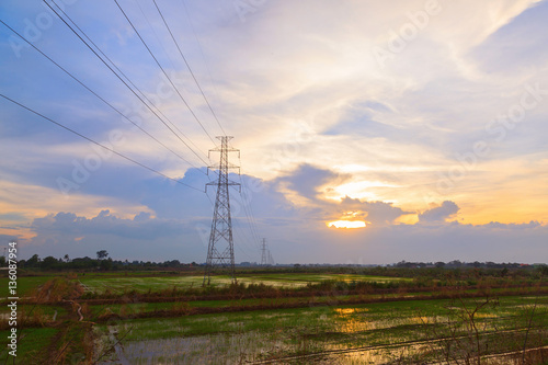 High electric pole at beautiful sunset twilight background © Akarapong Suppasarn