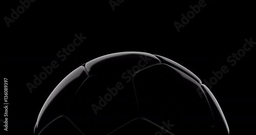 Soccer ball slowly rotate on black background