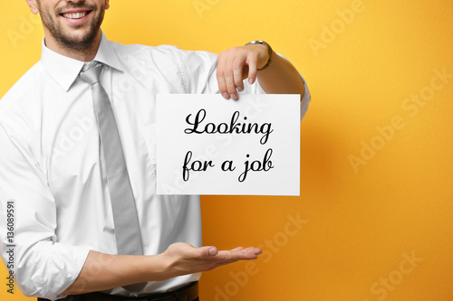 Man holding paper with text...