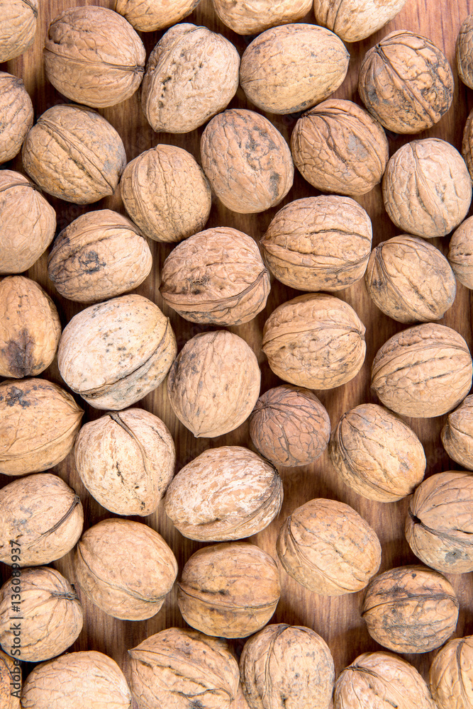 A lot of scattered walnuts close-up. A useful product. A lot of scattered walnuts close-up. A useful product.