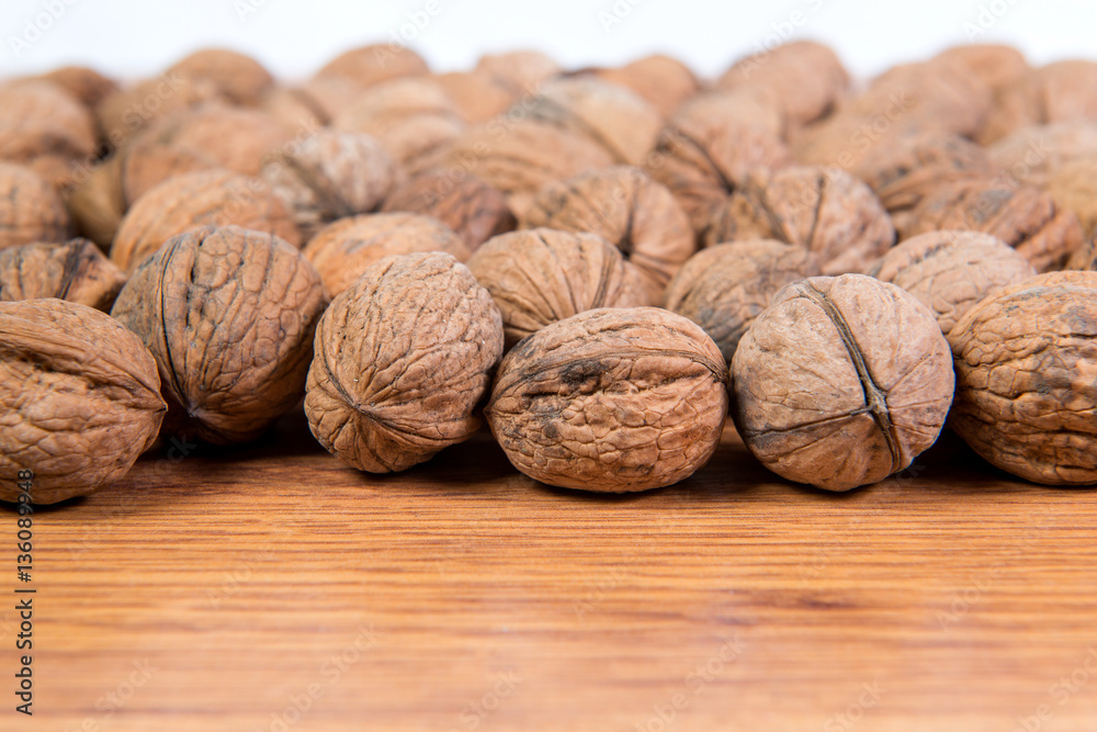 A lot of scattered walnuts close-up. A useful product. A lot of scattered walnuts close-up. A useful product.