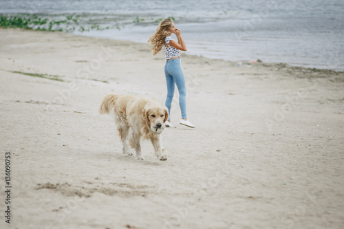 couple walking outdoors with her dog © hetmanstock2