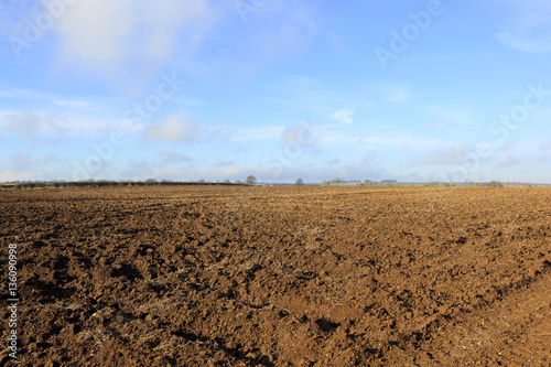 winter plow soil and blue sky background