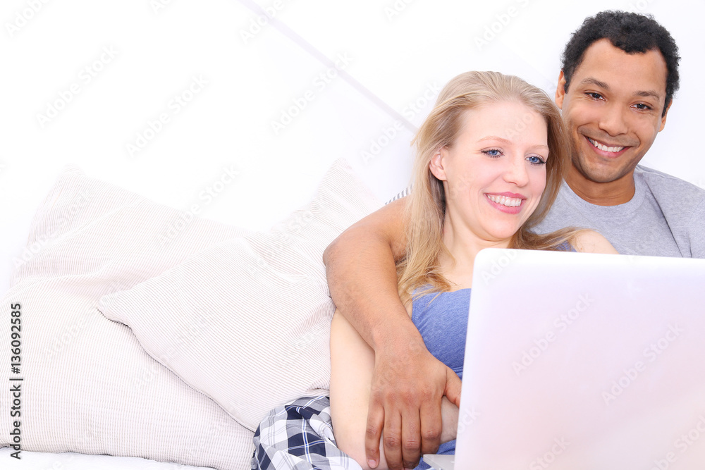 Young couple using laptop computer Young couple using laptop computer
