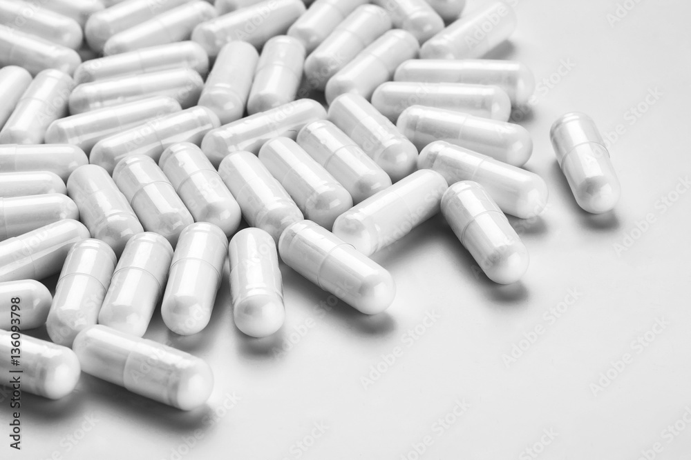 Many medicine capsules on gray background. High resolution product. Health care concept