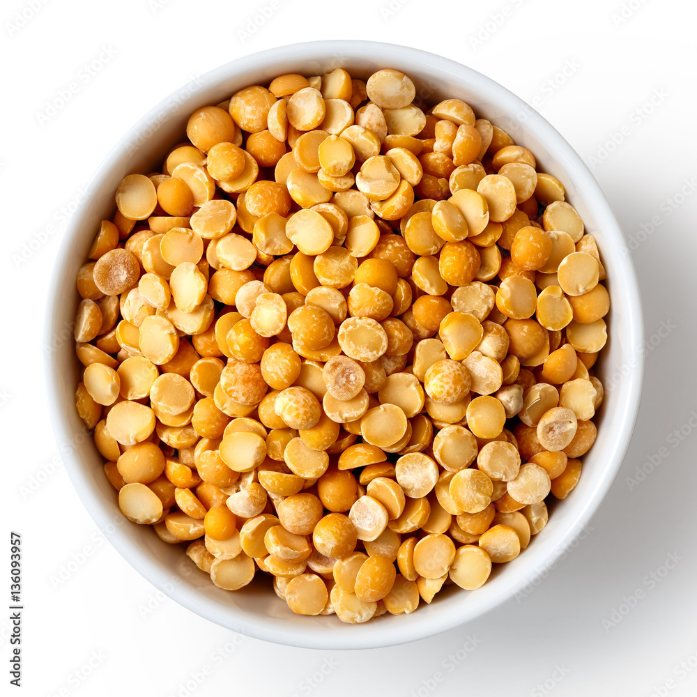 Dry yellow split peas in white ceramic bowl isolated on white. Dry yellow split peas in white ceramic bowl isolated on white.