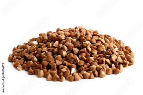Heap of dry buckwheat isolated on white.