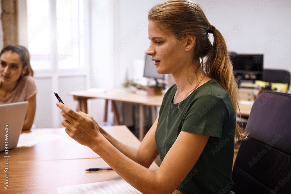 Young professional female reading a message Young professional female reading a message