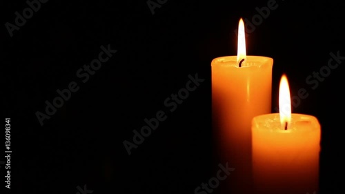 Two candles lit and extinguished. Bright light on dark background. RIP darkness template. Birthday party. Romantic evening on Valentine.