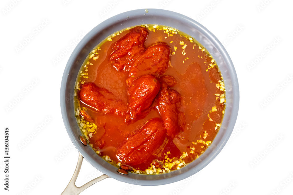 Canned tomatoes, garlic are fried in oil in a frying pan. Canned tomatoes, garlic are fried in oil in a frying pan.