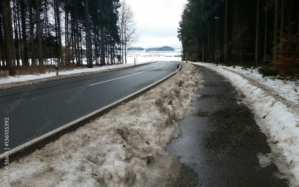 Schneeschmelze - schmutziger Schnee am Straßenrand bei Tauwetter - Nässe Schneeschmelze - schmutziger Schnee am Straßenrand bei Tauwetter - Nässe