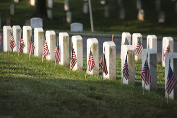 Grave markers with flags at Arlington National Cemetery on Memor