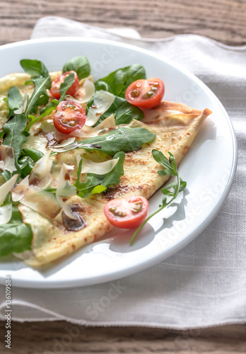 Crepes with cherry tomatoes, italian cheese and arugula