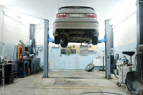 Car on a lift in a car repair station