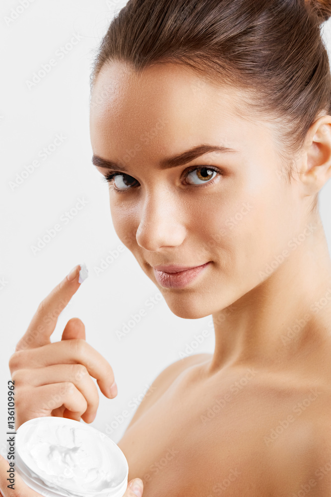 Beauty Skin Care. Beautiful Happy Woman Applying Cosmetic Cream On Clean Face. Closeup Portrait Of Healthy Smiling Female Model With Natural Makeup, Fresh Soft Pure Skin Applying Moisturizing Lotion Beauty Skin Care. Beautiful Happy Woman Applying Cosmetic Cream On Clean Face. Closeup Portrait Of Healthy Smiling Female Model With Natural Makeup, Fresh Soft Pure Skin Applying Moisturizing Lotion