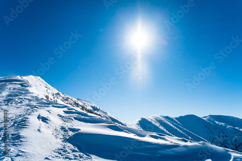 Snowy ridge of mountains, background winter mountains, winter landscape with sun, background european alps, european snowy landscape © marvlc