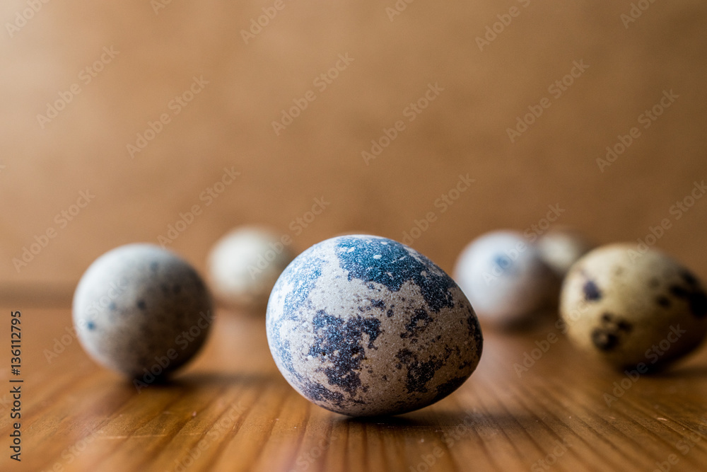 Quail Eggs on wooden surface.