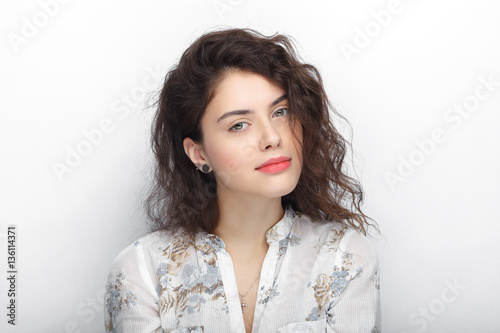 Beauty portrait of young adorable fresh looking brunette woman with long brown healthy curly hair. Emotion and facial expression lifestyle concept.