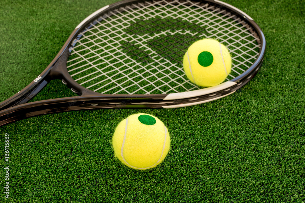tennis racket on green background