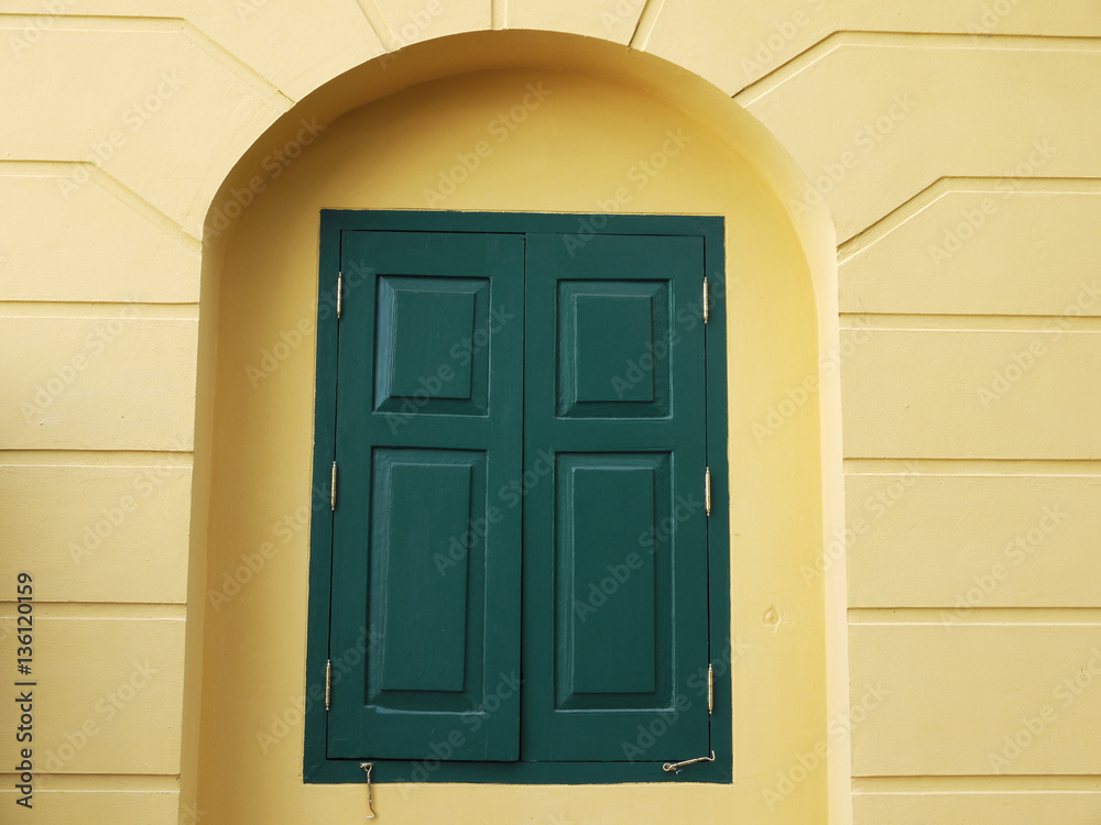 Green window on the yellow wall Green window on the yellow wall