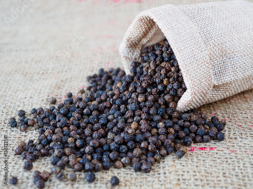 black pepper dry seed on brown hemp sack texture background