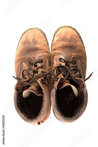 Pair of old brown working boots Isolated on white background.
