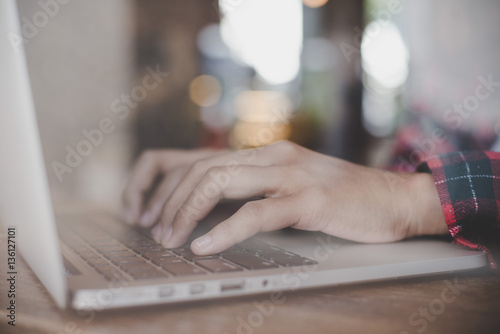 Close up of womanworking with her laptop at cafe.  photo