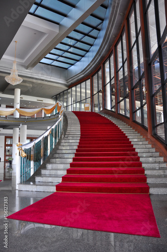 Elegant marble stairs with red carpet