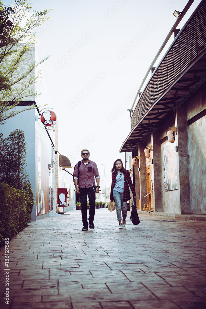 Portrait of hipster couple walking in the street urban. 