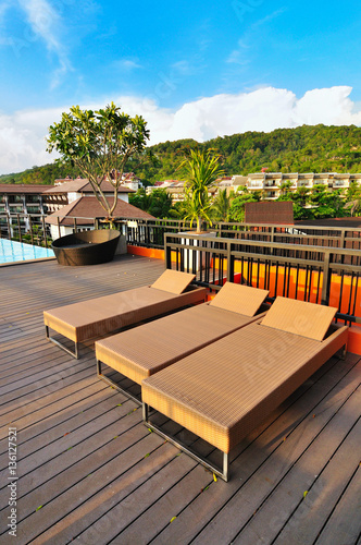 Rattan sunbeds at the poolside