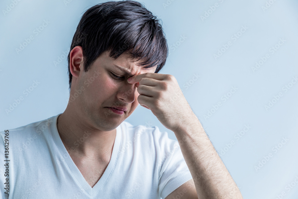 young man having a headache young man having a headache